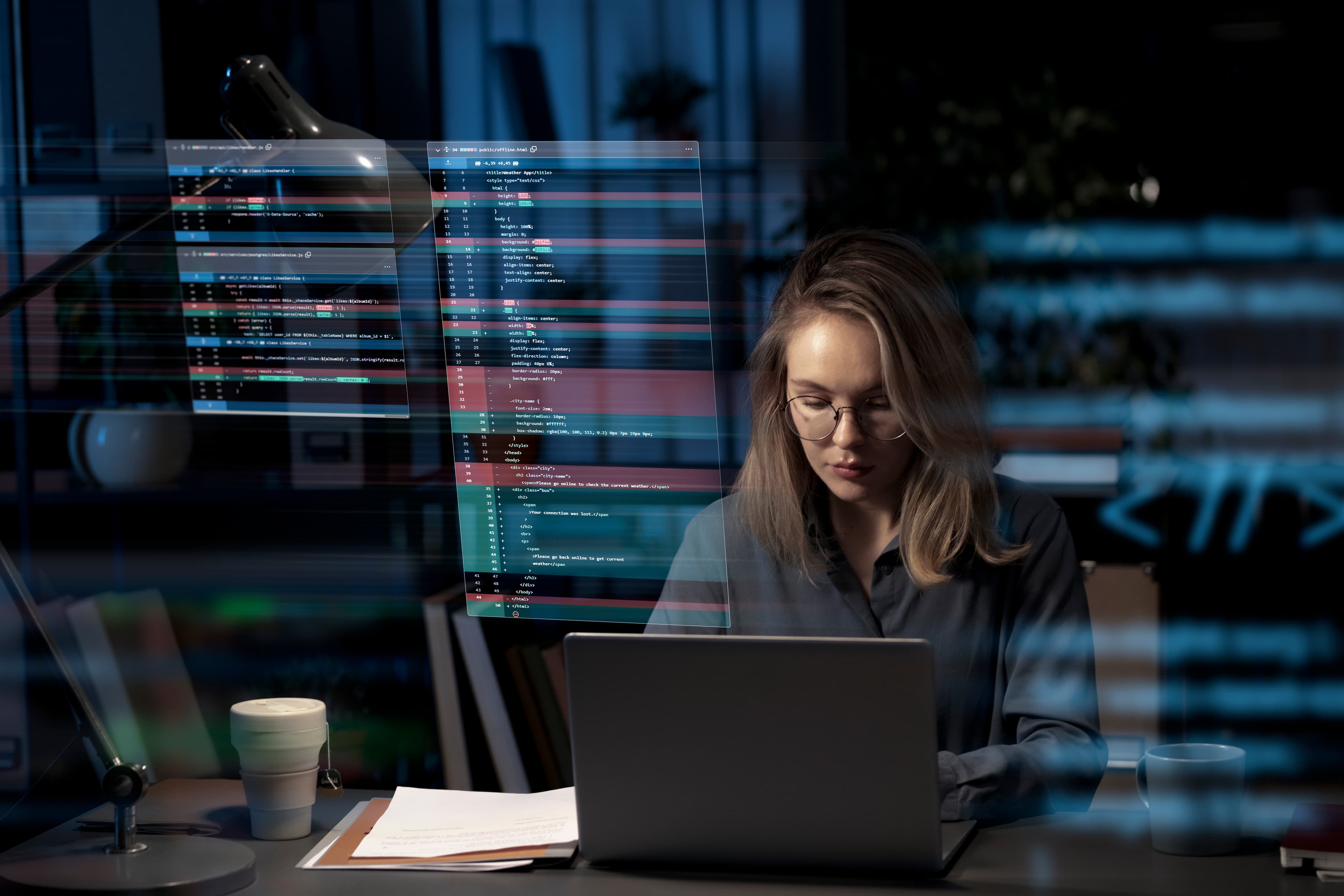 Developer working on a laptop with digital interface elements