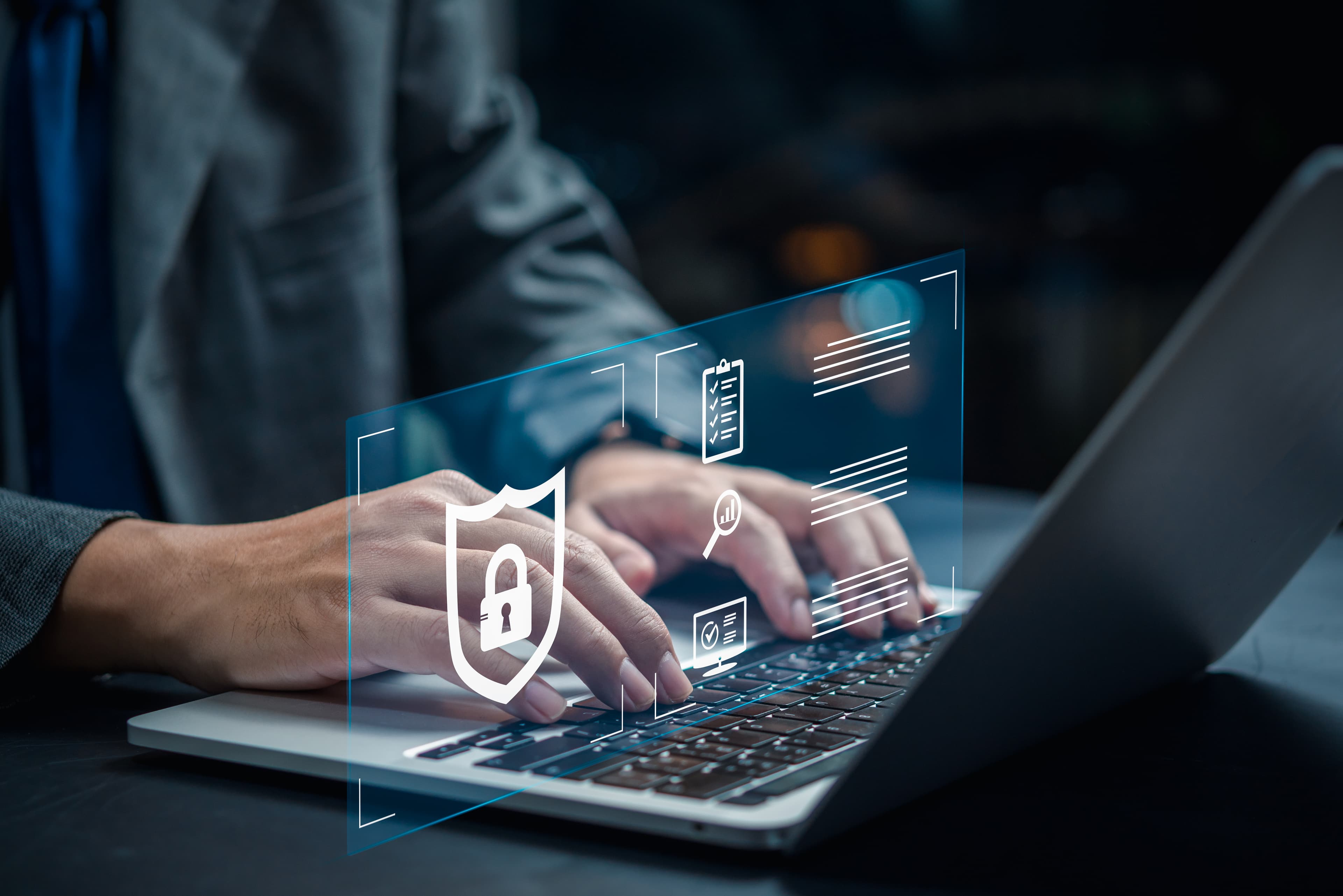 Person typing on a laptop with shield and lock icons